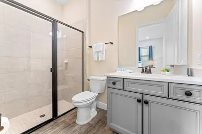 a bathroom with a toilet and a shower and a sink at Lafitte's Landing Lakeview Cottage - Lakefront in Orlando