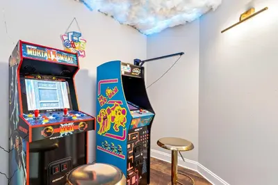 a room with a video game machine and a stool at Lake Views At Blue Heron in Orlando