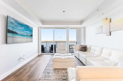 a living room with white furniture and a view of the ocean at Lake Views At Blue Heron in Orlando