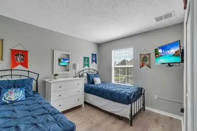 a bedroom with two beds and a window at Create Lasting Magical Memories Resort Home for 8 in Kissimmee