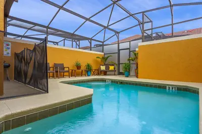 a large swimming pool in a building with a roof at Main Street Gem in Paradise Palms Resort in Kissimmee