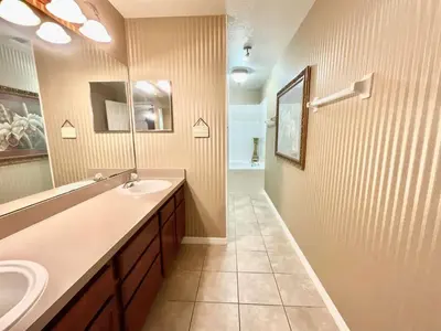 a bathroom with a sink and a mirror at Marcellas Villa At Acadia Estates in Orlando