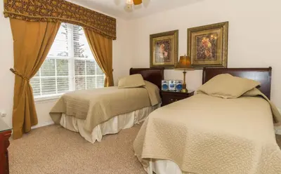 a bedroom with two beds and a window at Marcellas Villa At Acadia Estates in Orlando