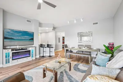 a living room with a large flat screen tv at Minutes to Magic in Orlando