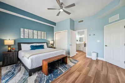 a bedroom with a bed and a ceiling fan at Minutes to Magic in Orlando