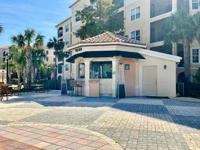 a small kiosk in a courtyard in front of a building at Minutes to Magic in Orlando
