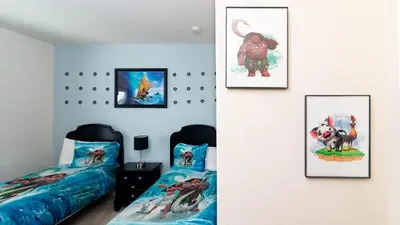 a bedroom with two beds and pictures on the wall at Moana's Hut - Miles from World's Best Theme Parks in Kissimmee