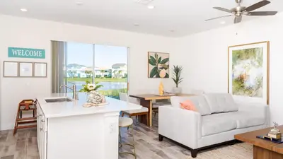 a kitchen and living room with a couch and a table at No Way Rose - Nearby Disney World & Universal in Orlando