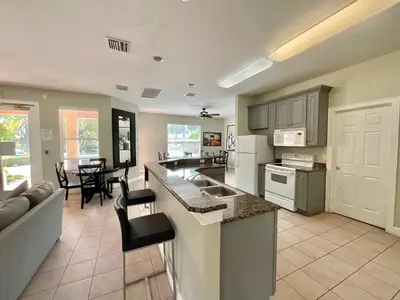 a kitchen and living room with a couch and a table at Once Upon a Stay in Kissimmee