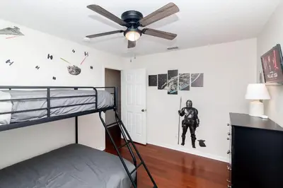 a bedroom with a bunk bed and a ceiling fan at New Ownership - 7BR - close to Disney in Orlando