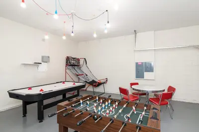 a room with a pool table and a ping pong table at New Ownership - 7BR - close to Disney in Orlando
