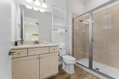 a bathroom with a toilet sink and a shower at Parrot Paradise Escape for 8 in Orlando