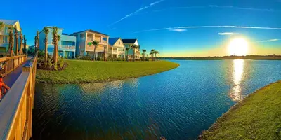 a view of a river with houses and palm trees at Parrot Paradise Escape for 8 in Orlando