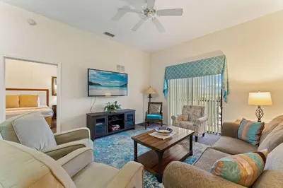 a living room with a couch and a table at Peaceful Horizons at Caribe Cove in Kissimmee