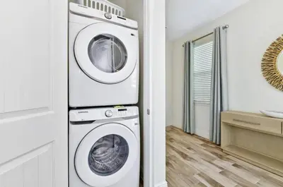 a white washer and dryer in a room at Pistachio Palace - Sleeps 10 in Orlando