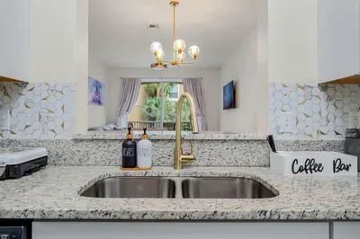 a kitchen sink with two bottles of wine on it at Windsor Hills Resort 2Bd with Great Amenities in Orlando