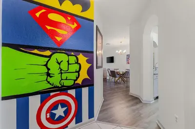 a hallway with a superhero painting on the wall at Windsor Hills Resort 2Bd with Great Amenities in Orlando