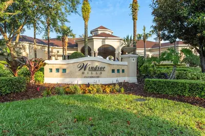 a building with a sign in front of a yard at Windsor Hills Resort 2Bd with Great Amenities in Orlando