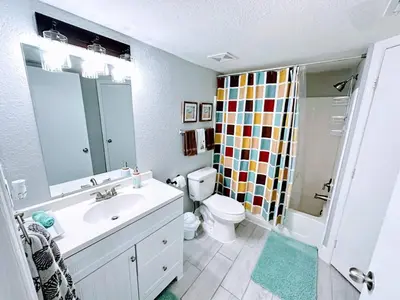 a bathroom with a sink and a toilet and a shower at Playing Hooky in Kissimmee