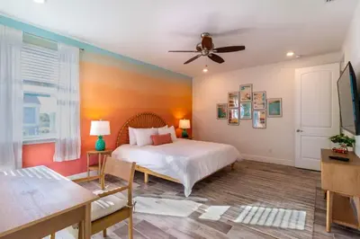 a bedroom with a bed and a ceiling fan at Rum Runners and Margaritas in Orlando