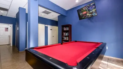 a billiard room with a red pool table at Slice Of Sunshine At Caribe Cove in Kissimmee