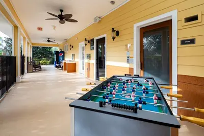 a pool table on the side of a house at Slice Of Sunshine At Caribe Cove in Kissimmee