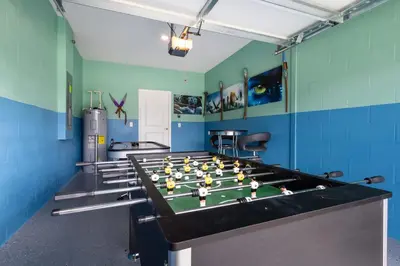 a room with a foosball table with dolls on it at Storeybook Escape - Sleeps 11 in Kissimmee