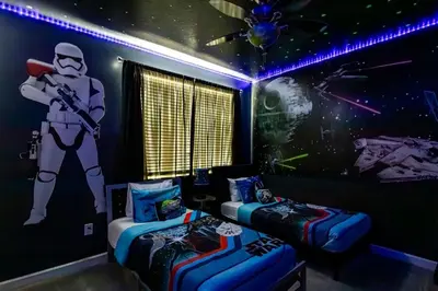 a room with two beds and a star wars mural at Storeybook Escape - Sleeps 11 in Kissimmee