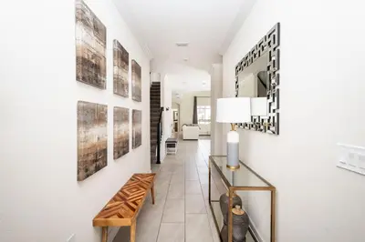 a hallway with art on the walls at Storeybook Escape - Sleeps 11 in Kissimmee