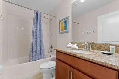 a bathroom with a sink and a tub and a toilet at Sun & Fun Storey Lake in Kissimmee
