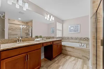 a bathroom with a tub and a sink and a bath tub at Sun & Fun Storey Lake in Kissimmee