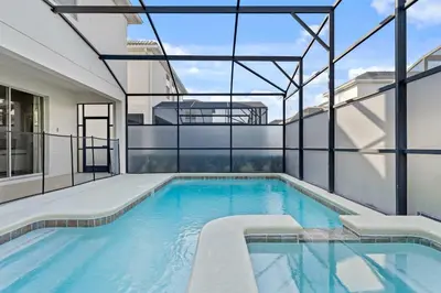 an indoor swimming pool with a view of a building at Sun & Fun Storey Lake in Kissimmee