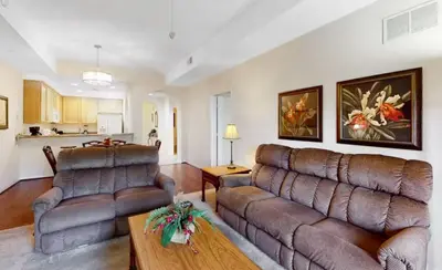 a living room with a couch and a table at Sunny Haven At Caribe Cove in Kissimmee