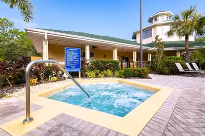 a swimming pool in front of a house at Sunny Haven At Caribe Cove in Kissimmee