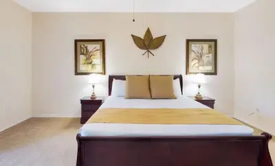 a bedroom with a large bed with two lamps at Sunny Haven At Caribe Cove in Kissimmee