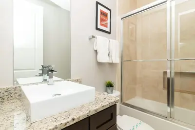 a bathroom with a sink and a shower at Sunrise in Kissimmee - Near Disney World in Orlando