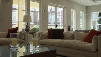 a living room with a couch and a table at Sunrise in Kissimmee - Near Disney World in Orlando