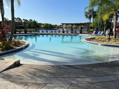 a large swimming pool with blue water at Terra Verde - Resort Amenities & More in Kissimmee