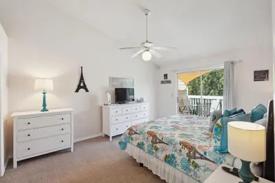 a bedroom with a bed and a dresser and a window at 2466 Sweetwater in Kissimmee