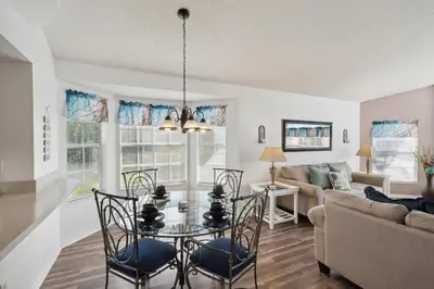 a living room with a table and chairs and a couch at 2466 Sweetwater in Kissimmee
