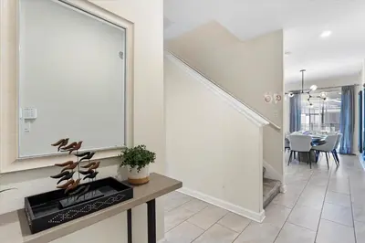 a hallway with a large mirror and a dining room at 4 Bedrooms - 3 Bathrooms - Storey Lake 4818Ml in Kissimmee