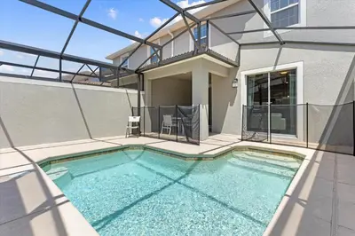 a swimming pool in the backyard of a house at 4 Bedrooms - 3 Bathrooms - Storey Lake 4818Ml in Kissimmee