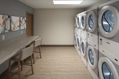 a laundry room with a row of washing machines at Candlewood Suites Orlando North - Winter Park by IHG in Orlando