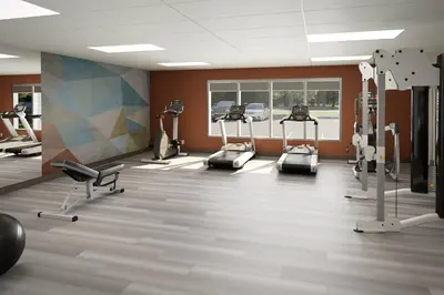 a gym with treadmills and machines in a room at Candlewood Suites Orlando North - Winter Park by IHG in Orlando