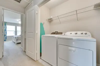 a kitchen with a washer and dryer in a room at 4 Mi to WDW Sleek Townhome with Community Pool! in Kissimmee