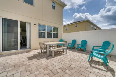a patio with a table and chairs on a patio at 4 Mi to WDW Sleek Townhome with Community Pool! in Kissimmee