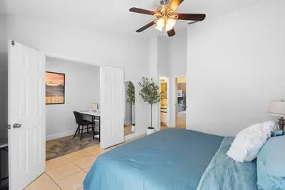 a bedroom with a blue bed and a ceiling fan at Enjoy your Summer Near to Disney- Universal-Epic in Kissimmee