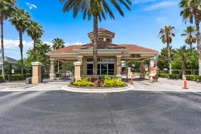 a building with a palm tree in front of it at Disney Retreat w/ Wizard & Galaxy Rooms in Orlando