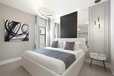 a bedroom with a large white bed in a room at Magical 15-Bedroom Villa | Game Room, Theater & More! in Kissimmee