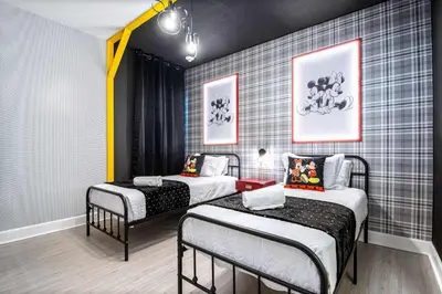 a room with two twin beds in it at Themed Kids' Rooms, Pool & Game Loft Near Disney in Kissimmee
